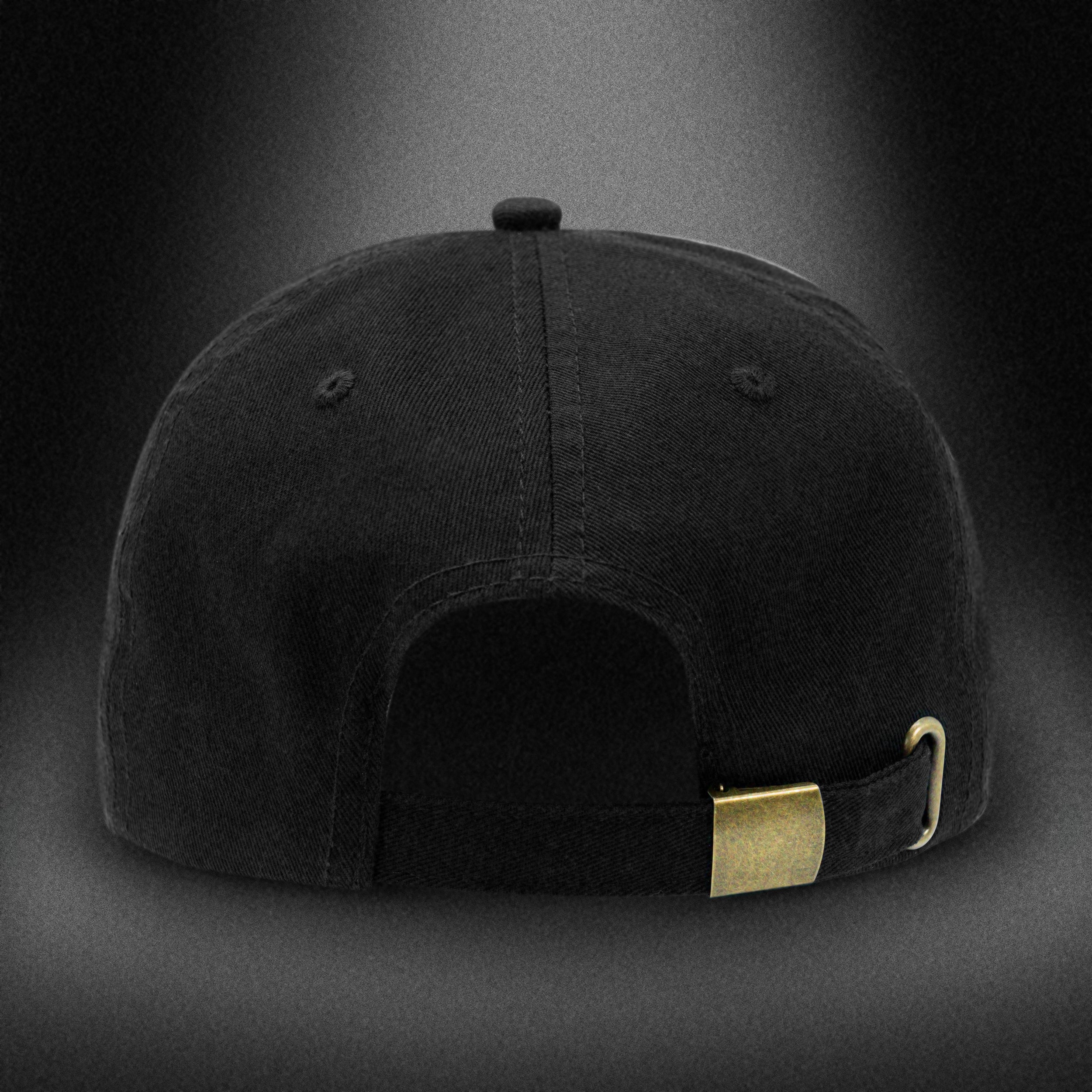 Back view of the Tigerclaw Black Stash cap in monochrome, showcasing the adjustable strap with a matte brass buckle detail, photographed against a dark spotlight gradient background.