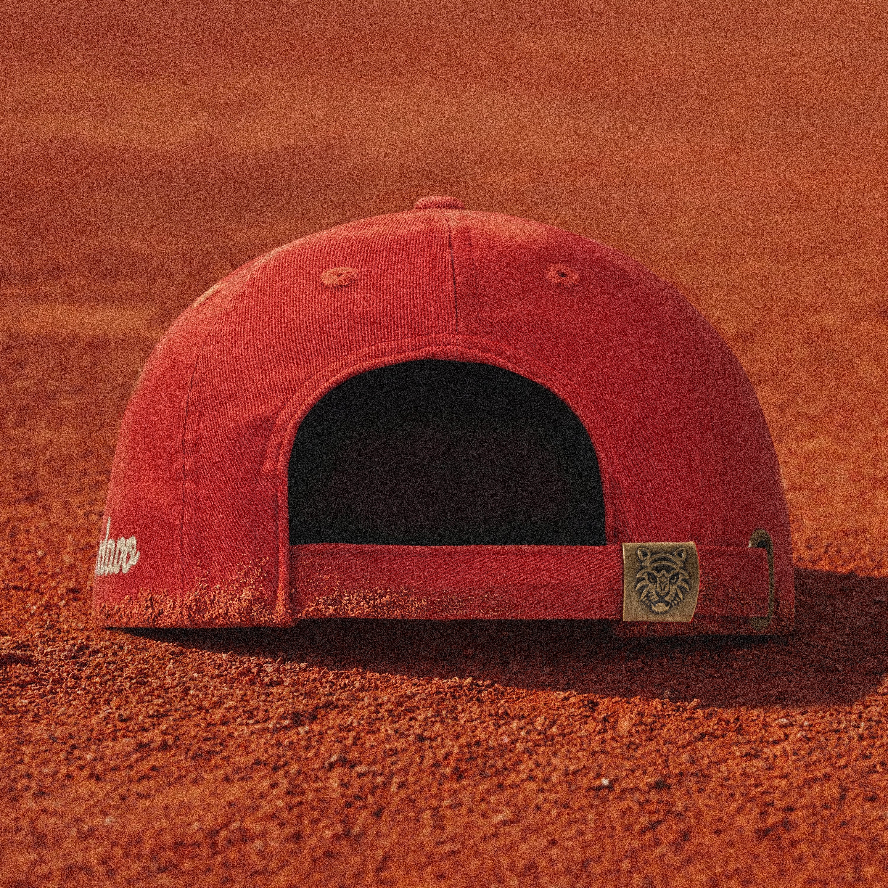 Adjustable strapback closure with custom Tigerclaw metal hardware. Finished in matching clay terracotta for a clean, uninterrupted silhouette.
