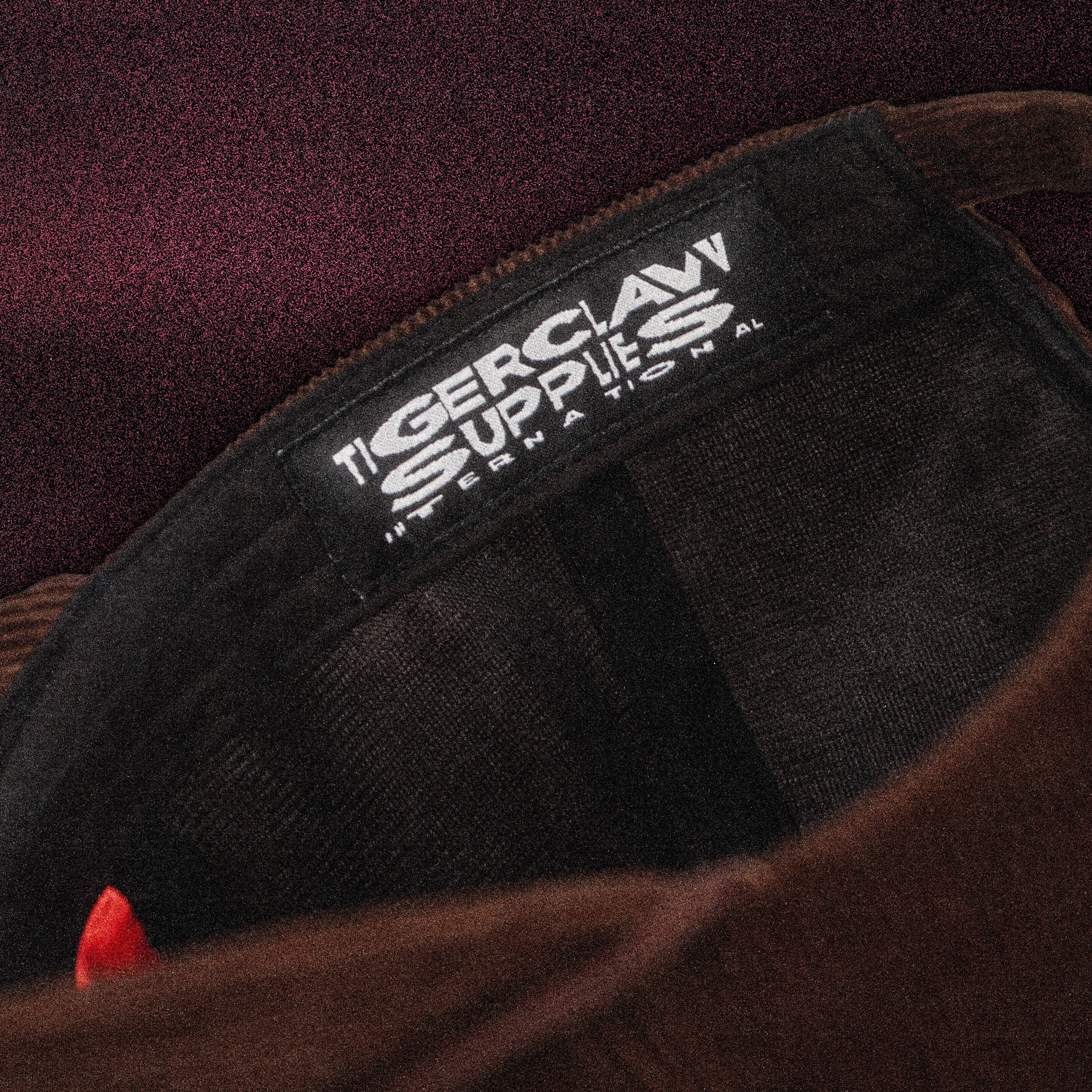 Close-up of the Tigerclaw Baskerville Canidrome cap interior featuring a woven Tigerclaw Supplies label, premium headwear construction and custom finishing details