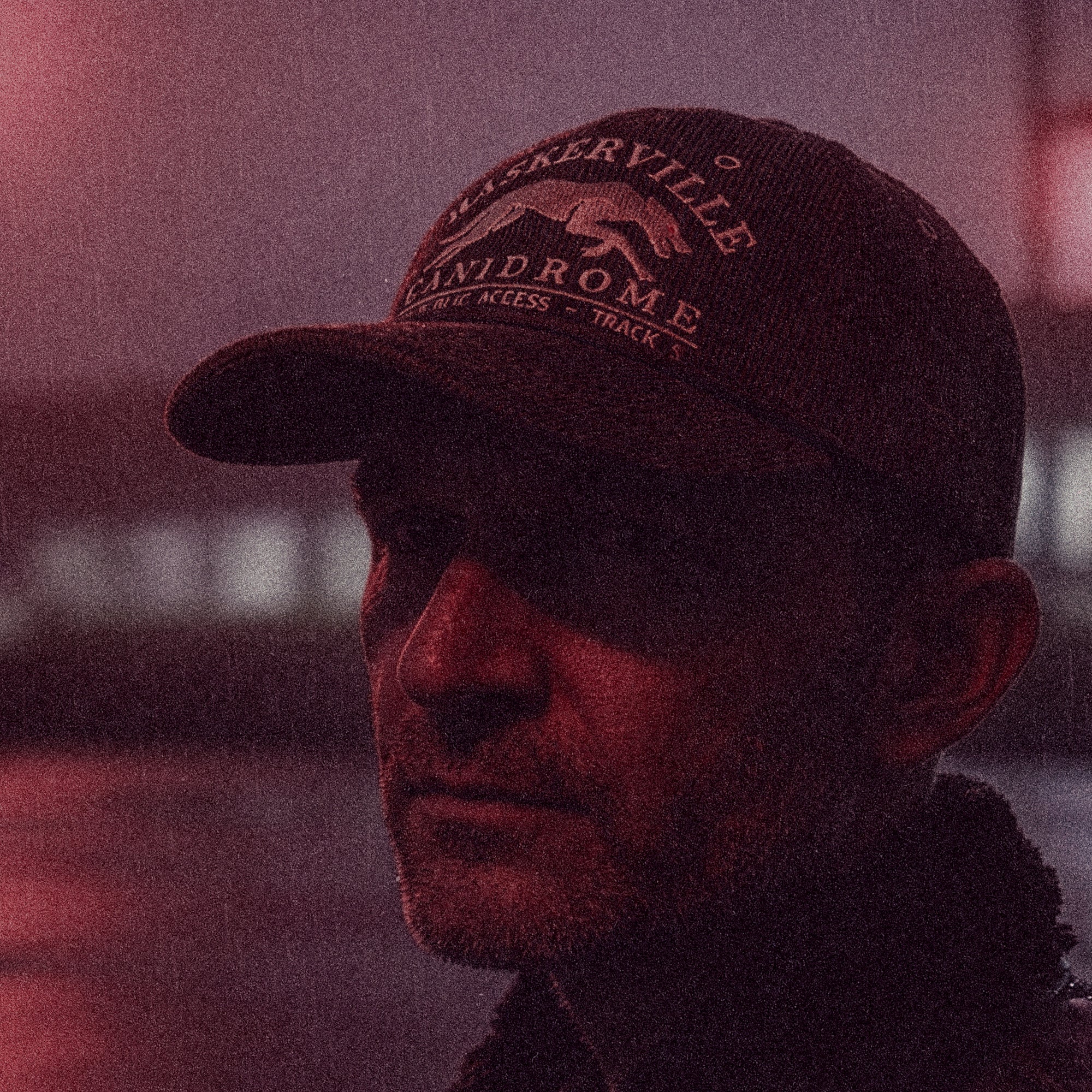 Lifestyle portrait featuring the Tigerclaw Baskerville Canidrome cap with premium corduroy construction and greyhound embroidery