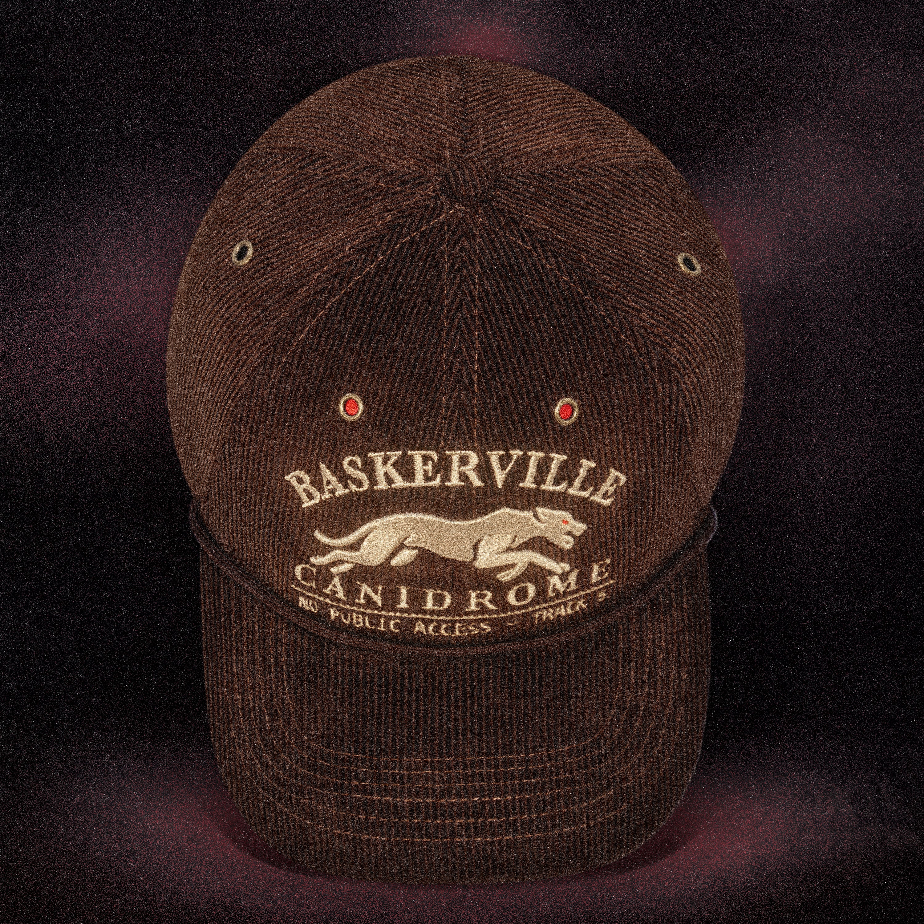 Front view of the Tigerclaw Baskerville Canidrome corduroy strapback cap featuring embroidered greyhound artwork and vintage racing-inspired headwear design.