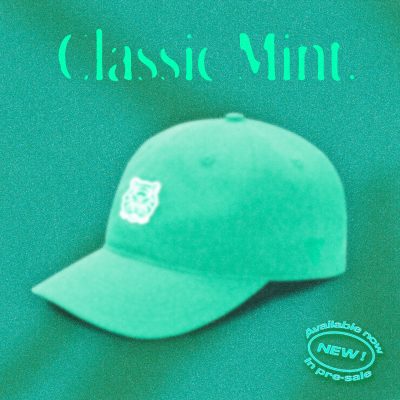 A mint green "Classic Mint" Tigerclaw strapback cap set against a textured mint-toned backdrop, with bold serif headline text above the cap and a clean front angle showcasing the white embroidered tiger logo.