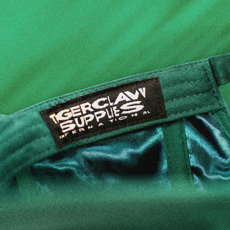 Close-up of Tigerclaw Supplies interior label stitched onto satin lining inside the Green Legacy cap.