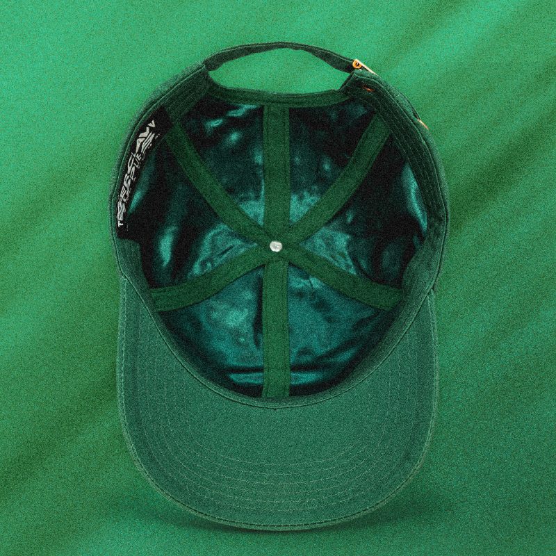 Top view of the Green Legacy cap interior, showing satin lining, internal panel structure, and Tigerclaw label.