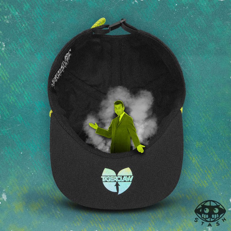Inside view of black 6-panel cap with stash pocket, featuring a vapor cloud and a surreal neon-green cutout figure of a man in a suit emerging from the hat. Holographic Tigerclaw logo on brim, STASH icon at bottom right.