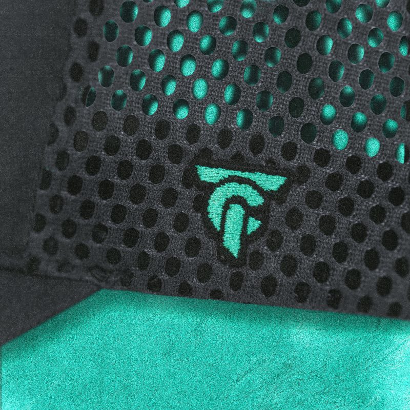 Close-up of mesh back on Tigerclaw Wild Ride trucker cap, featuring embroidered turquoise logo detail.