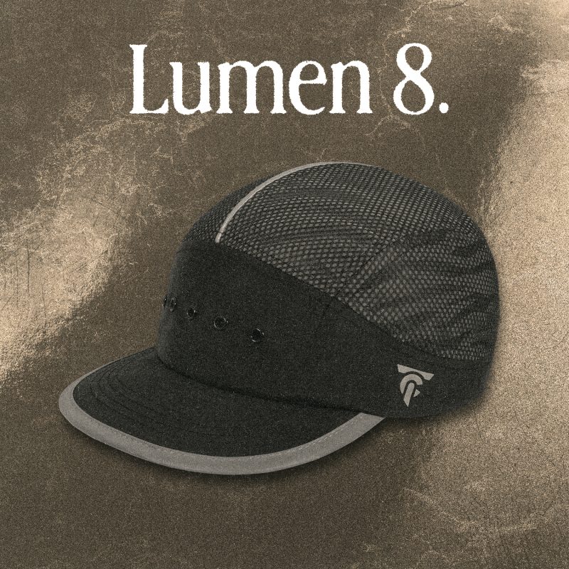 Reflective black 8-panel running cap “LUMEN8” by Tigerclaw, glowing under light.