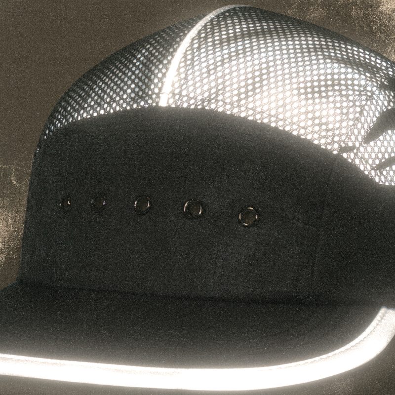 Front view of the Tigerclaw LUMEN8 running cap with reflective brim glowing under light.