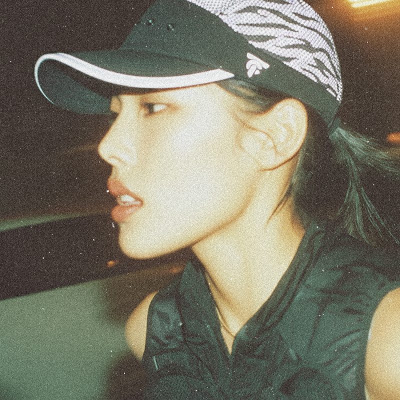 Close-up side view of a runner wearing the Tigerclaw LUMEN8 reflective cap at night, showing reflective mesh panels.
