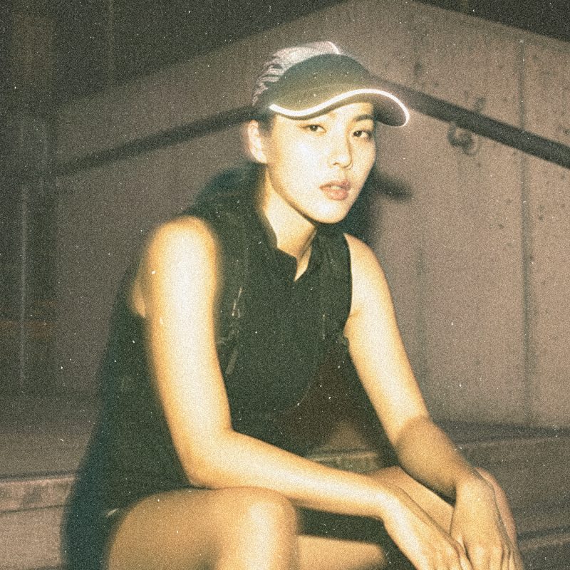 Runner wearing the Tigerclaw LUMEN8 reflective 8-panel cap, photographed at night.